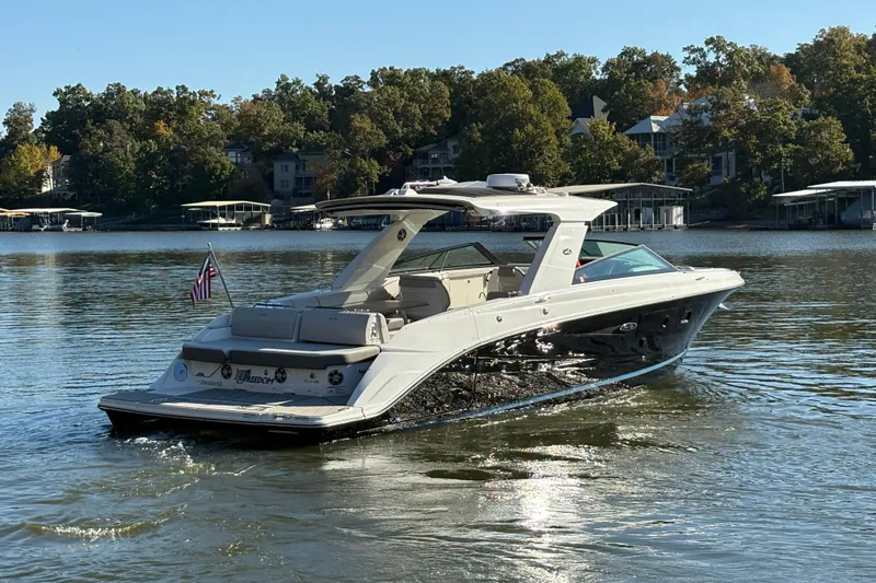 Slide: The Image of 2023 Sea Ray SLX 400 luxury boat cruising on a serene lake. - 6