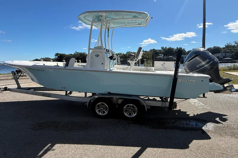 Slide: The Image of 2020 Tidewater 2300 Carolina Bay boat on trailer, parked near waterfront. - 11