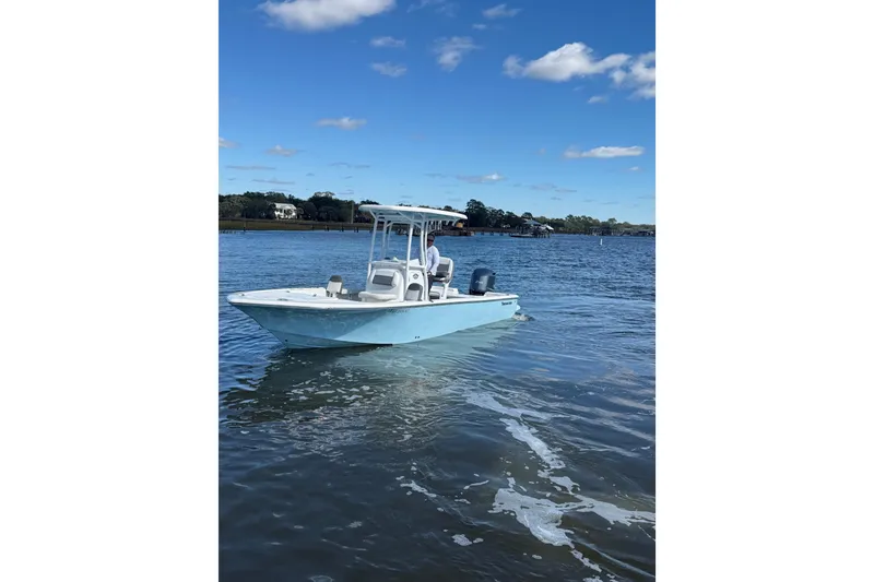 Slide: The Image of 2020 Tidewater 2300 Carolina Bay boat on calm water under blue sky. - 2