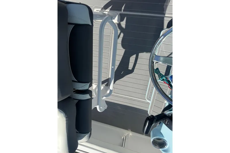 Slide: The Image of 2020 Tidewater 2300 Carolina Bay boat interior with steering wheel and seating. - 22