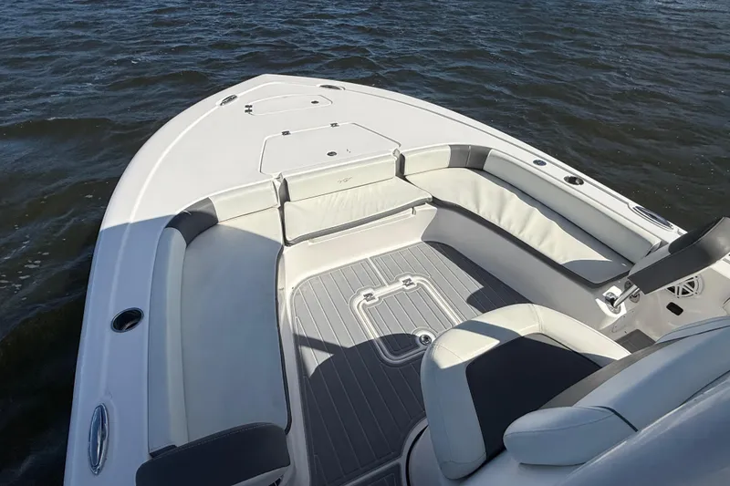 Slide: The Image of 2020 Tidewater 2300 Carolina Bay boat interior with cushioned seating on the water. - 23