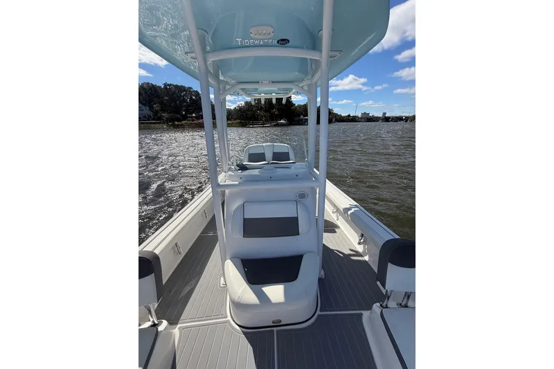 Slide: The Image of 2020 Tidewater 2300 Carolina Bay boat on water, featuring sleek design and spacious deck. - 24