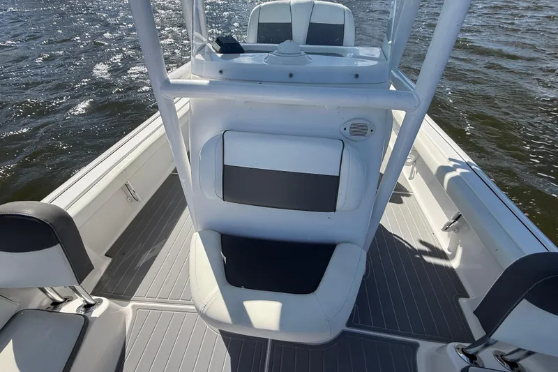 Slide: The Image of 2020 Tidewater 2300 Carolina Bay boat interior with seating and console on water. - 25
