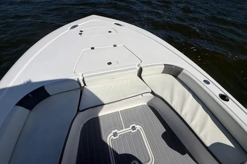 Slide: The Image of 2020 Tidewater 2300 Carolina Bay boat interior with cushioned seating and storage compartments. - 26