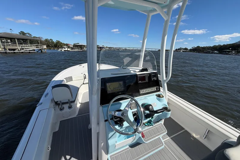 Slide: The Image of 2020 Tidewater 2300 Carolina Bay boat on water, featuring modern helm and controls. - 29