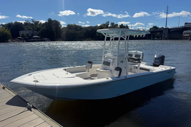Slide: The Image of 2020 Tidewater 2300 Carolina Bay boat docked on a sunny river. - 32