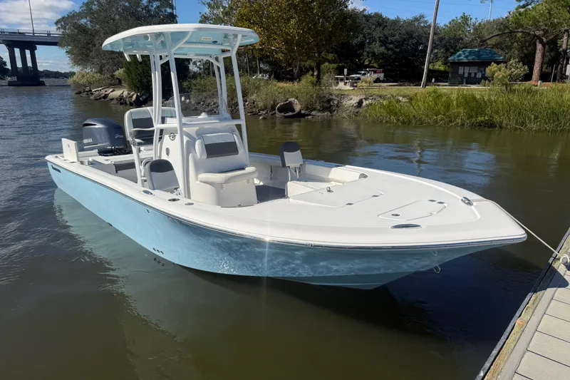 Slide: The Image of 2020 Tidewater 2300 Carolina Bay boat docked on calm water. - 33