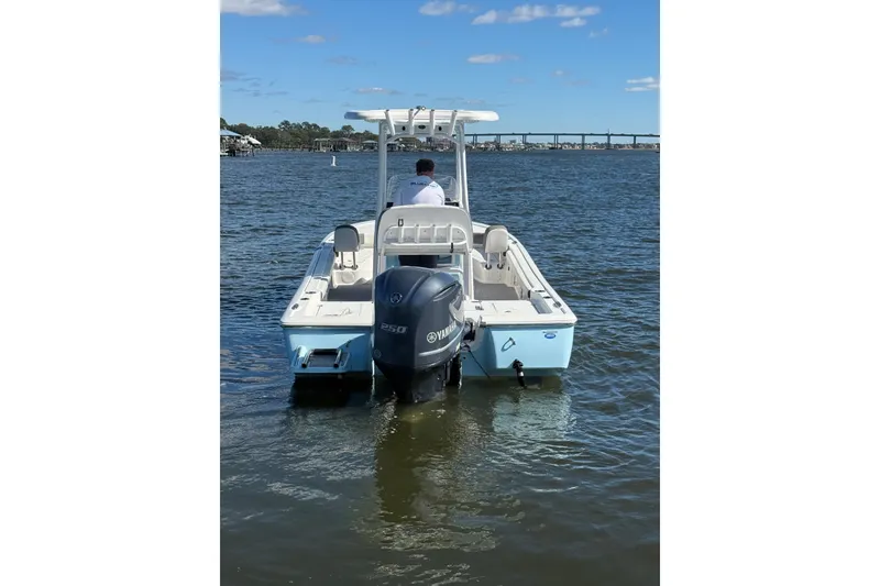 Slide: The Image of 2020 Tidewater 2300 Carolina Bay boat on calm water under blue sky. - 7
