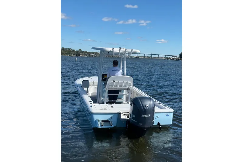 Slide: The Image of 2020 Tidewater 2300 Carolina Bay boat on water, rear view with outboard motor. - 8