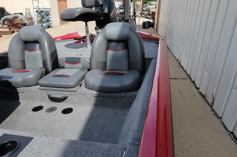 Slide: The Image of 2022 Bass Tracker Pro Team 175 XTE boat interior with gray and red seating. - 16