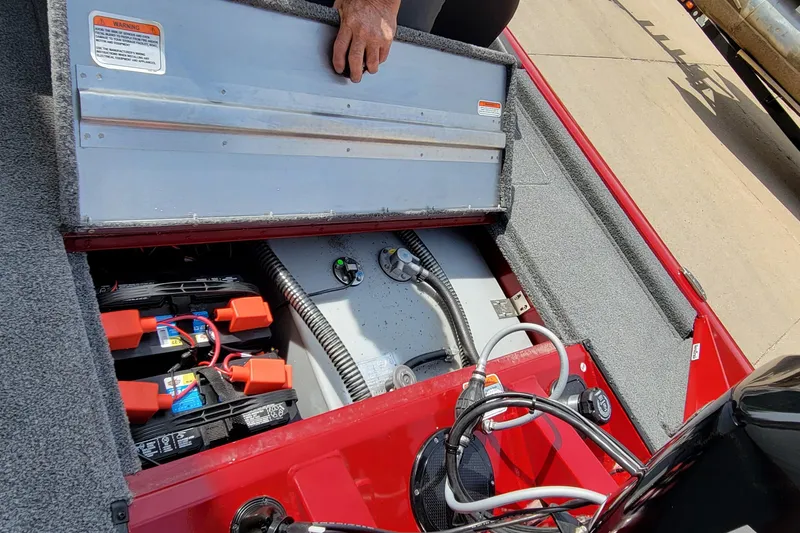 Slide: The Image of 2022 Bass Tracker Pro Team 175 XTE boat battery compartment with wiring and components. - 21