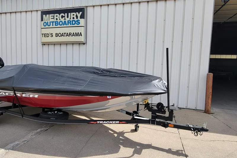 Slide: The Image of 2022 Bass Tracker Pro Team 175 XTE boat covered, parked outside Ted's Boatarama. - 23