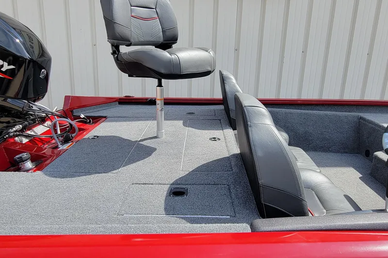 Slide: The Image of 2022 Bass Tracker Pro Team 175 XTE boat interior with seating and motor. - 12