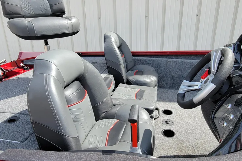 Slide: The Image of 2022 Bass Tracker Pro Team 175 XTE boat interior with gray and red seating. - 13