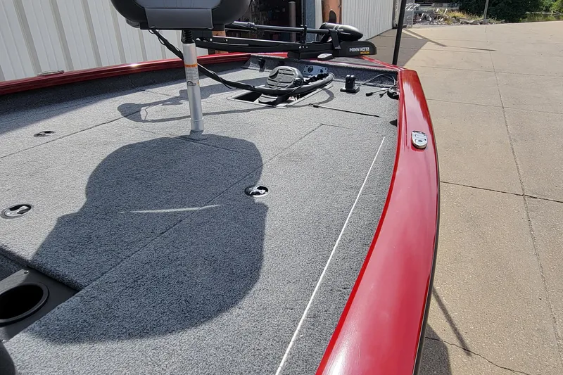 Slide: The Image of 2022 Bass Tracker Pro Team 175 XTE boat deck with red trim and fishing equipment. - 14