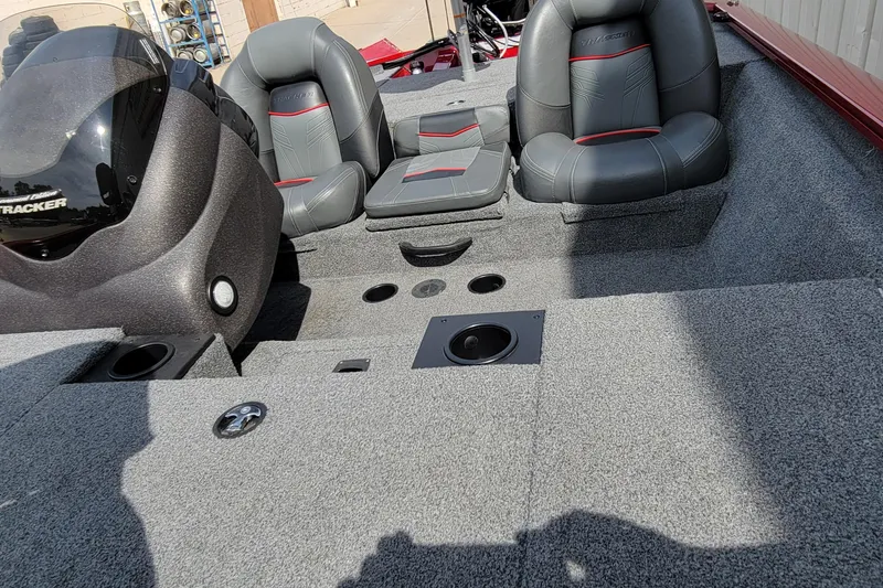 Slide: The Image of 2022 Bass Tracker Pro Team 175 XTE boat interior with gray seating and carpeted flooring. - 17