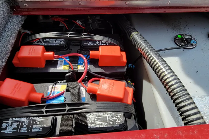 Slide: The Image of Battery compartment of 2022 Bass Tracker Pro Team 175 XTE boat, featuring dual batteries. - 19