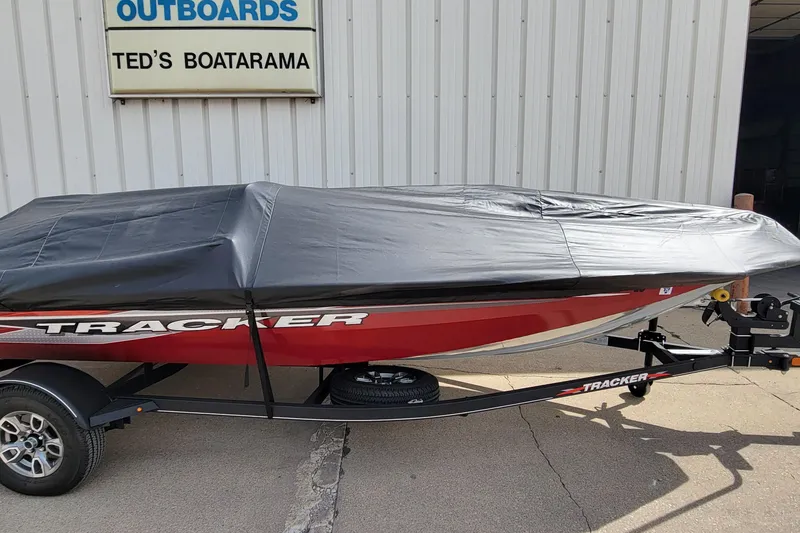 Slide: The Image of 2022 Bass Tracker Pro Team 175 XTE boat covered, parked at Ted's Boatarama. - 22