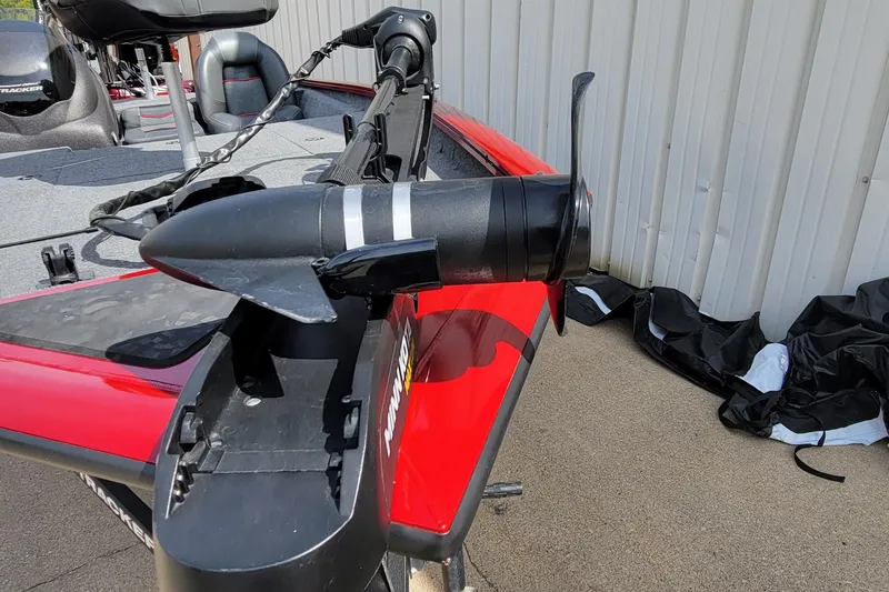 Slide: The Image of 2022 Bass Tracker Pro Team 175 XTE boat with trolling motor, red and black design. - 8