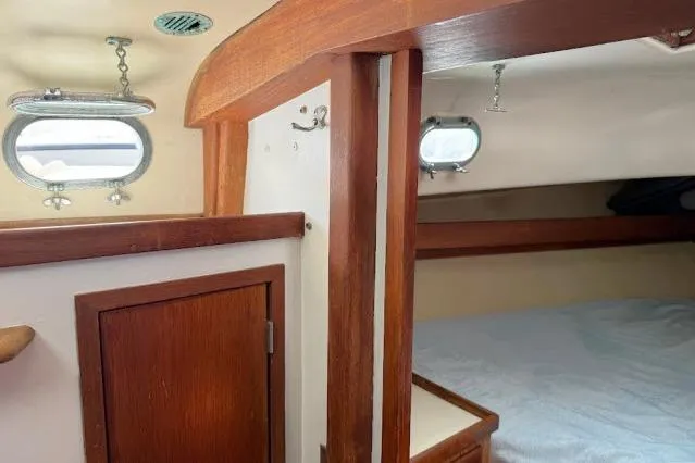 Slide: The Image of Interior of a 1965 Pearson Alberg 35 sailboat with wooden accents and portholes. - 11