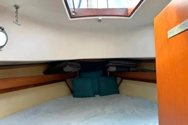 Slide: The Image of 1965 Pearson Alberg 35 sailboat cabin interior with skylight and cushions. - 12