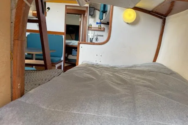 Slide: The Image of Interior of a 1965 Pearson Alberg 35 sailboat, featuring a cozy cabin with a bed. - 14