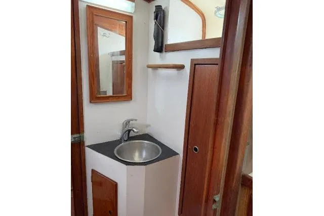 Slide: The Image of 1965 Pearson Alberg 35 yacht bathroom with sink, mirror, and wooden cabinetry. - 15