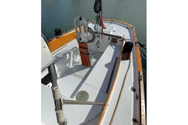 Slide: The Image of 1965 Pearson Alberg 35 sailboat deck with wooden trim and steering wheel. - 17