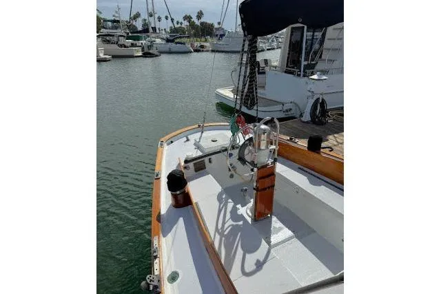 Slide: The Image of 1965 Pearson Alberg 35 sailboat docked in a marina, showcasing its classic design. - 18