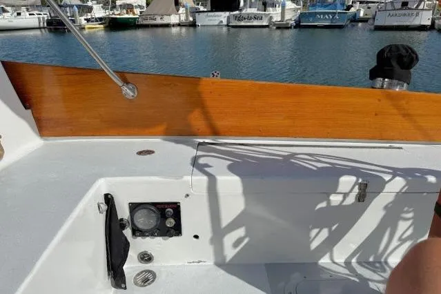 Slide: The Image of 1965 Pearson Alberg 35 sailboat cockpit with wooden trim and marina view. - 20