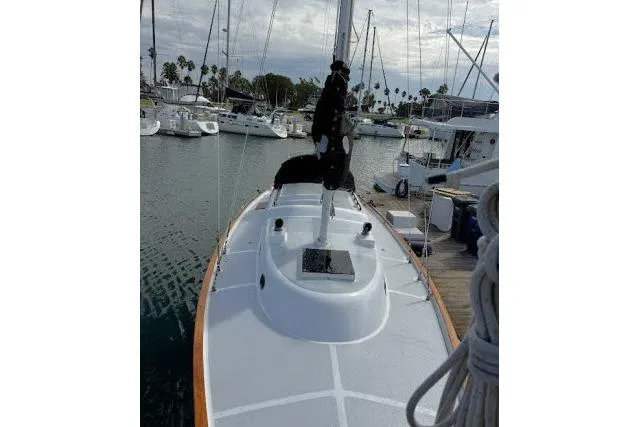 Slide: The Image of 1965 Pearson Alberg 35 sailboat docked in a marina, surrounded by other boats. - 23