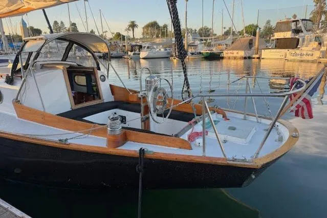 Slide: The Image of 1965 Pearson Alberg 35 sailboat docked in a marina, featuring classic design and wooden accents. - 27