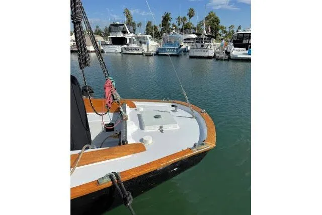 Slide: The Image of 1965 Pearson Alberg 35 sailboat docked in a marina with other boats. - 28