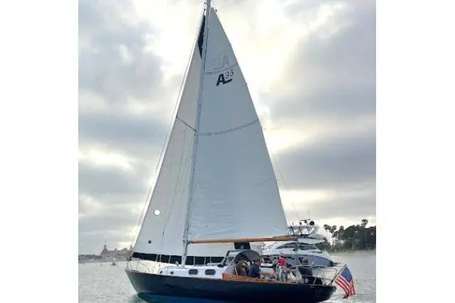 Slide: The Image of 1965 Pearson Alberg 35 sailboat on calm water under cloudy sky. - 34