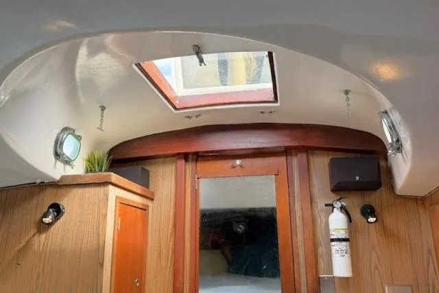 Slide: The Image of Interior of a 1965 Pearson Alberg 35 sailboat with wooden cabinetry and skylight. - 4