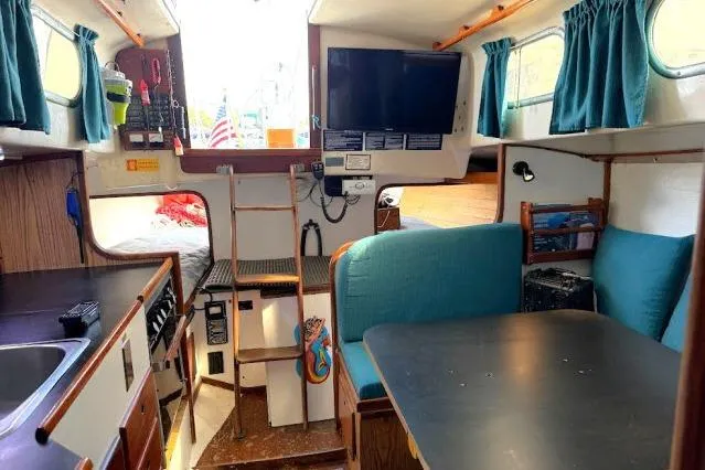 Slide: The Image of Interior of a 1965 Pearson Alberg 35 sailboat with cozy seating and nautical decor. - 5