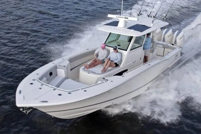 Slide: The Image of Manufacturer Provided Image: 2025 Scout 357 LXF boat cruising on water with passengers enjoying the ride. - 0