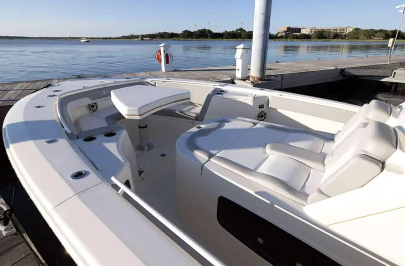 Slide: The Image of Manufacturer Provided Image: 2025 Scout 357 LXF boat interior at dock, featuring sleek seating and modern design. - 3