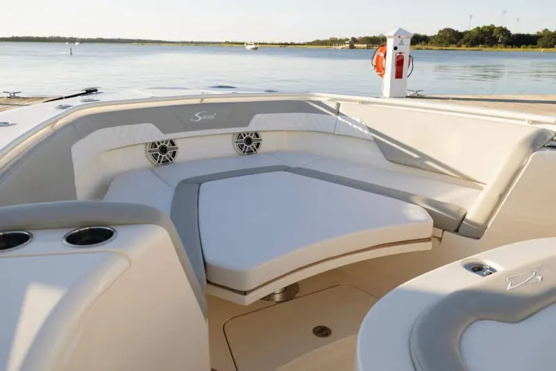 Slide: The Image of Manufacturer Provided Image: 2025 Scout 357 LXF boat interior with cushioned seating and scenic water view. - 4