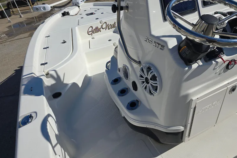Slide: The Image of 2017 NauticStar 215 XTS boat interior with steering wheel and speaker system. - 12