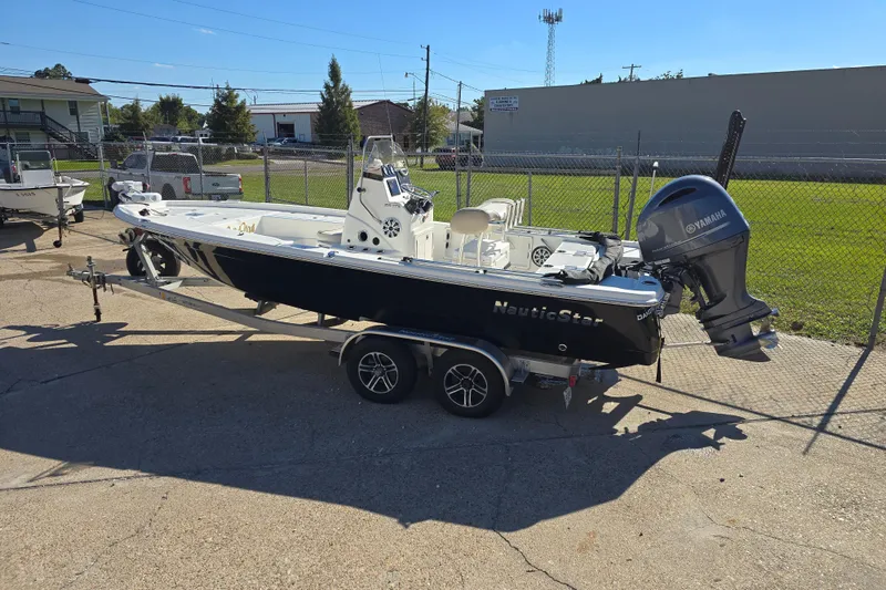 Slide: The Image of 2017 NauticStar 215 XTS boat on trailer with Yamaha outboard motor. - 2