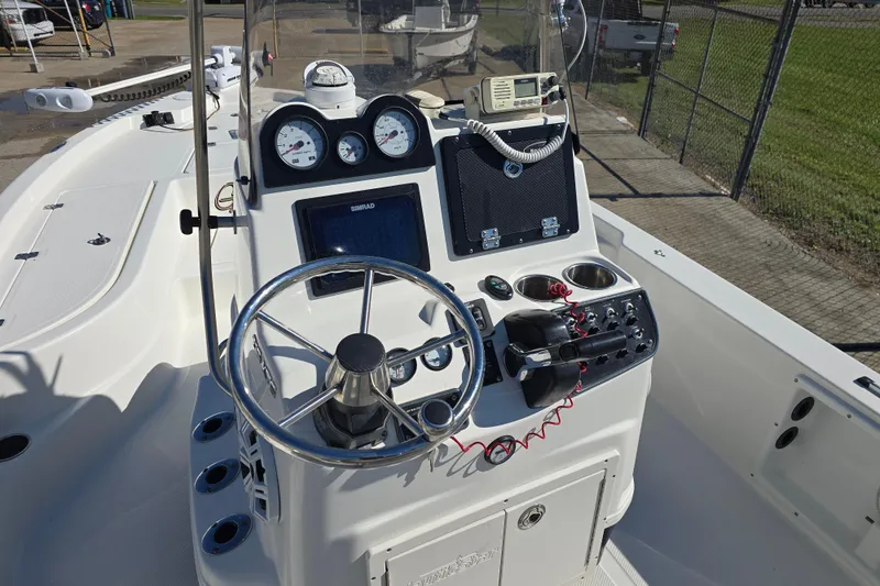 Slide: The Image of 2017 NauticStar 215 XTS boat console with steering wheel and navigation controls. - 9