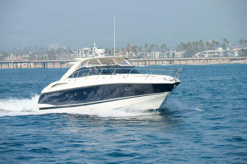 The Image of Sunseeker Camargue 50 yacht cruising near a coastal city, 2000 model. - 0