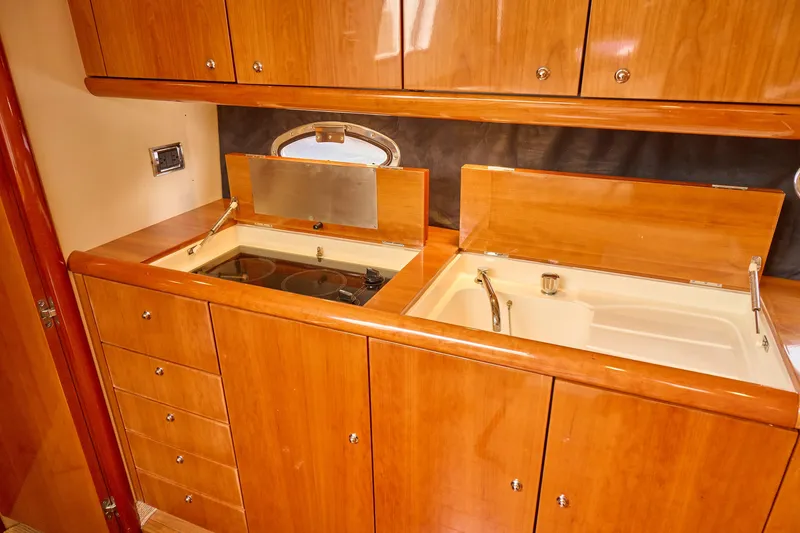 Slide: The Image of Luxurious wooden kitchen interior on a 2000 Sunseeker Camargue 50 yacht. - 14