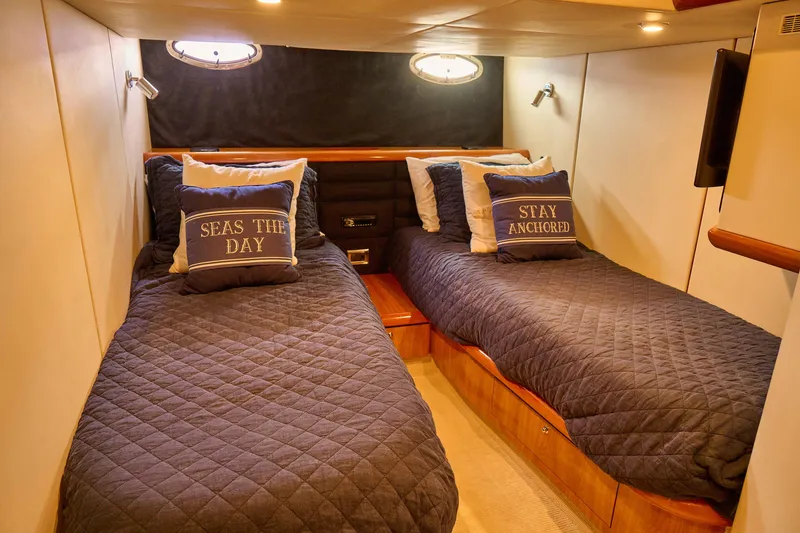Slide: The Image of Twin cabin in 2000 Sunseeker Camargue 50 yacht with nautical-themed pillows. - 16