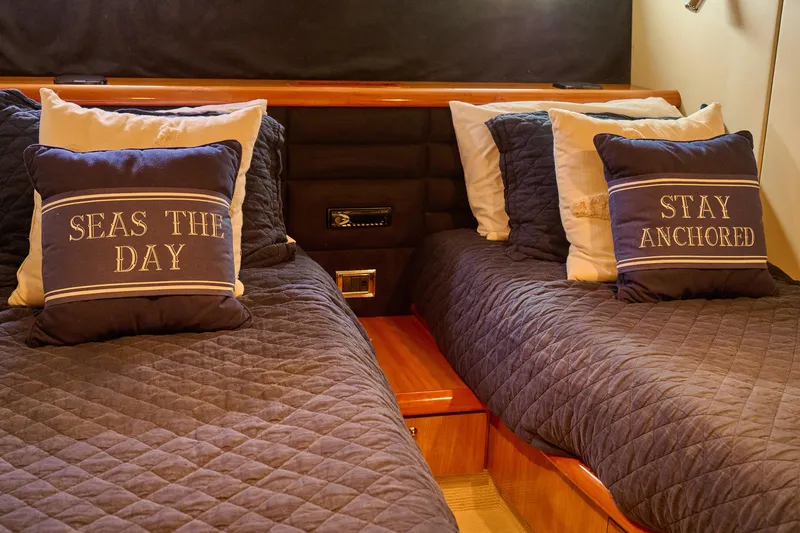 Slide: The Image of Cozy cabin interior of 2000 Sunseeker Camargue 50 with nautical-themed pillows. - 17