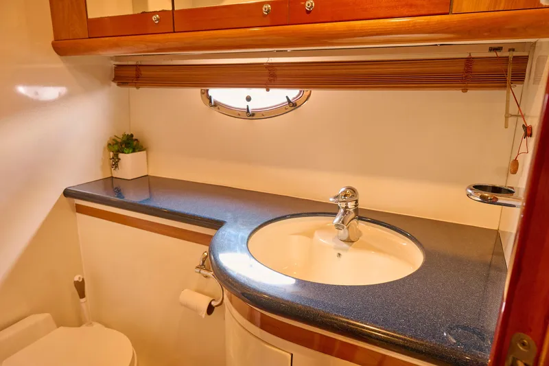 Slide: The Image of Luxurious bathroom in 2000 Sunseeker Camargue 50 yacht with sleek sink and wooden accents. - 19