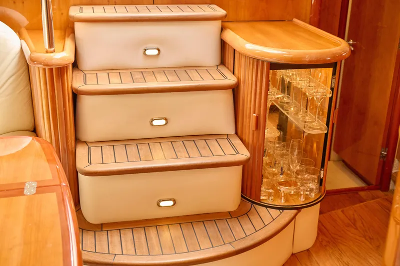 Slide: The Image of Luxurious interior of 2000 Sunseeker Camargue 50 yacht with elegant wooden steps and glass cabinet. - 26