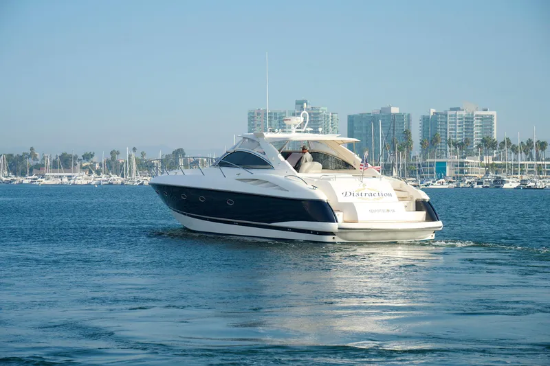 Slide: The Image of Sunseeker Camargue 50 yacht cruising in marina, 2000 model, cityscape background. - 3