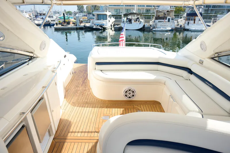 Slide: The Image of Luxurious Sunseeker Camargue 50 yacht interior with elegant seating, docked at a marina. - 40